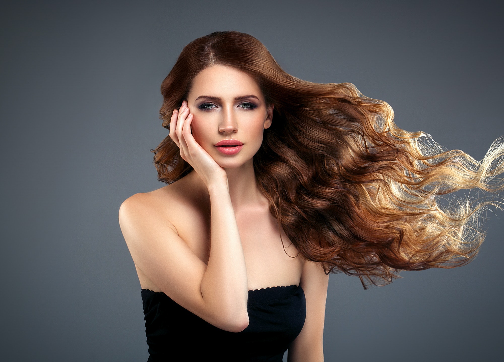 Beautiful hair woman beauty skin portrait over dark background. Long beautiful healthy hair mode