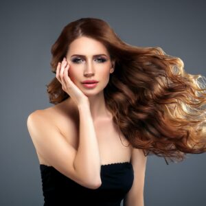 Beautiful hair woman beauty skin portrait over dark background. Long beautiful healthy hair mode
